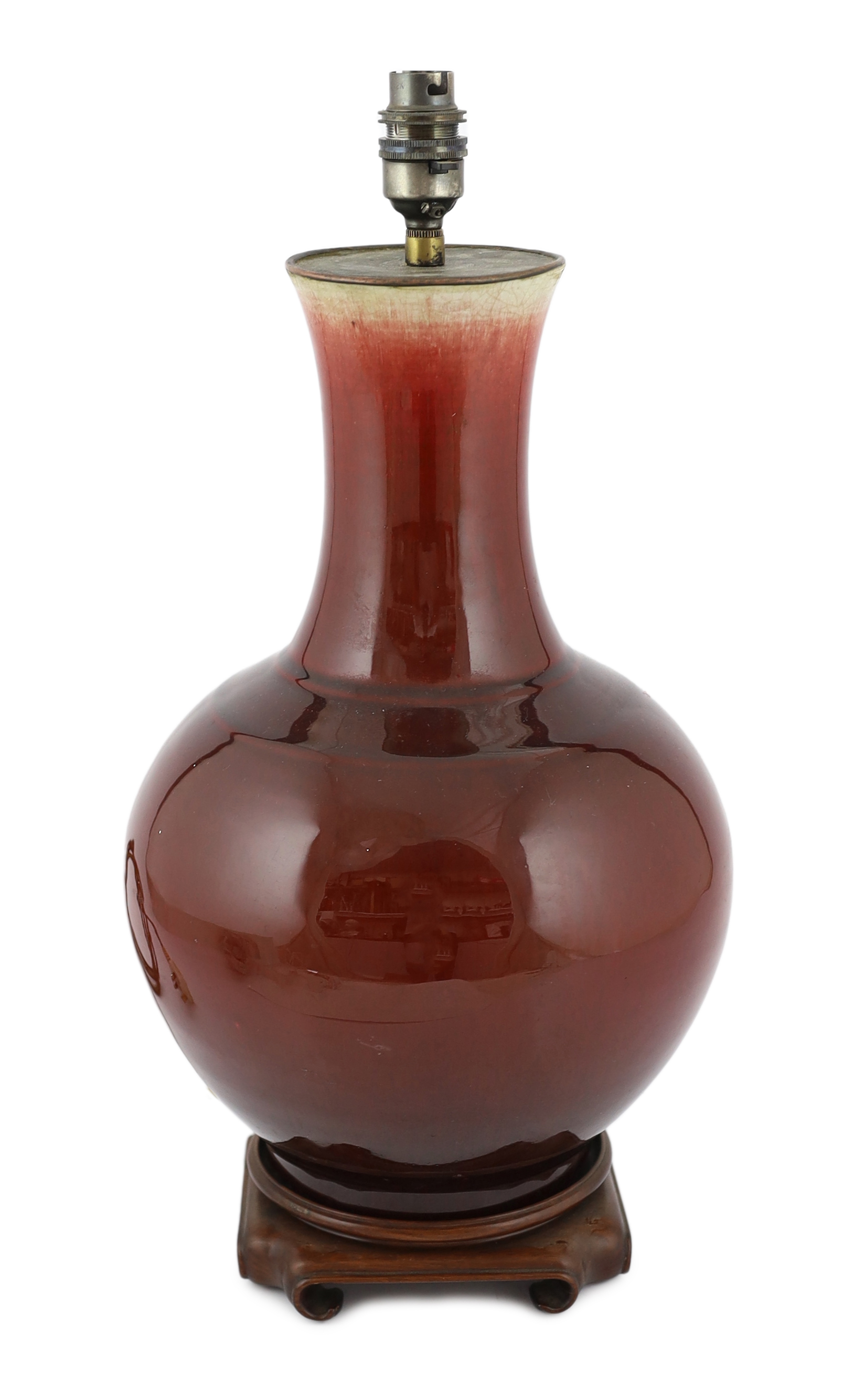 A Chinese sang de boeuf glazed vase, 19th century, the crackle glaze graduating from mushroom grey to copper red, later drilled and mounted as a lamp, height including wood stand 40.5cm, restored rim